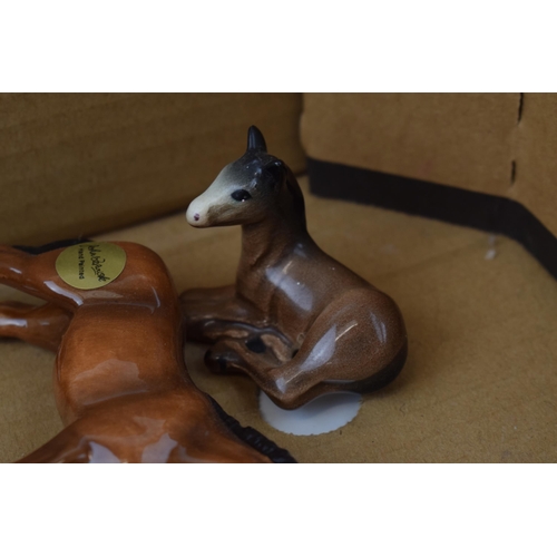 127 - Beswick animals to include an owl, brown foals, a palomino foal, a modern Beswick foal and an unmark... 