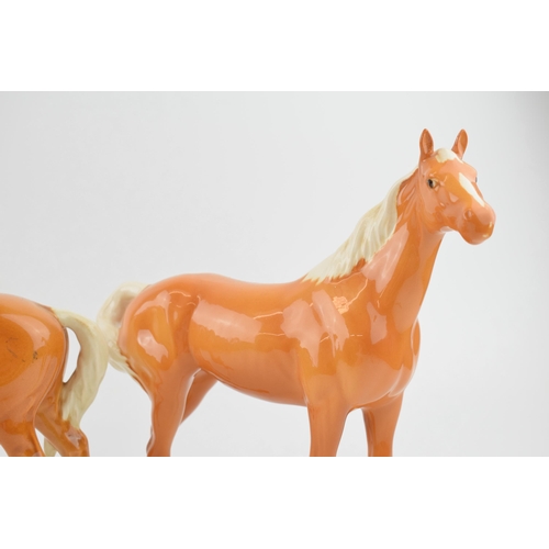 131 - Beswick palomino horses to include a swishtail and a mare facing left (2).