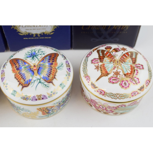 16 - A set of four Royal Crown Derby Butterflies of The World circular trinket pots and covers, comprisin... 