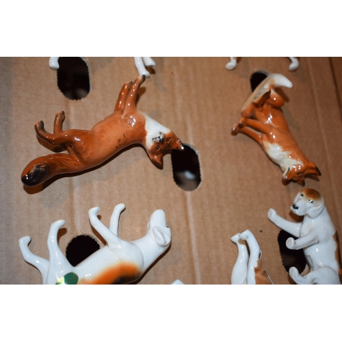 166 - A collection of Beswick hunting themed animals to include foxhounds, foxes and beagles (7).