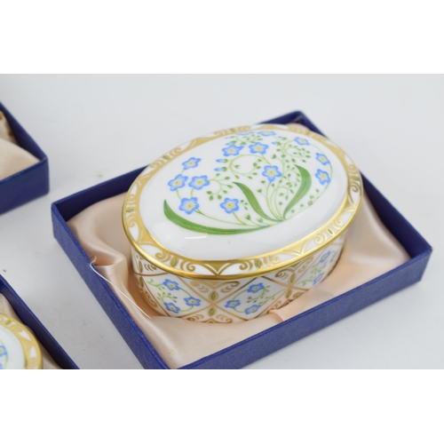 17 - A set of four Royal Crown Derby Forget-Me-Not pattern graduated oval trinket dishes and covers, the ... 