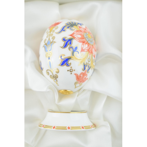 19 - Three Royal Crown Derby Eggs of the World on stands, 2 x Russia pattern and a Japan pattern. each 8c... 