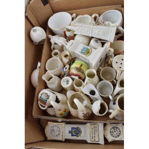 43 - A collection of crested china items to include animals, jugs, vases and varying forms and decoration... 