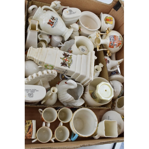 43 - A collection of crested china items to include animals, jugs, vases and varying forms and decoration... 