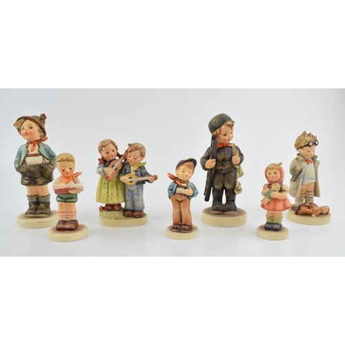50 - A collection of Goebel and Hummel child figures to include a girl with a doll, a boy with ladders, a... 