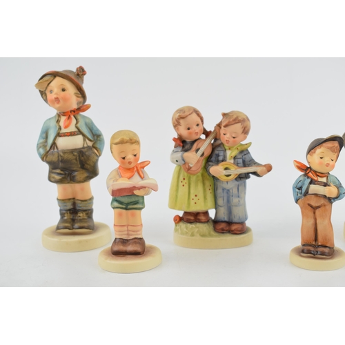 50 - A collection of Goebel and Hummel child figures to include a girl with a doll, a boy with ladders, a... 