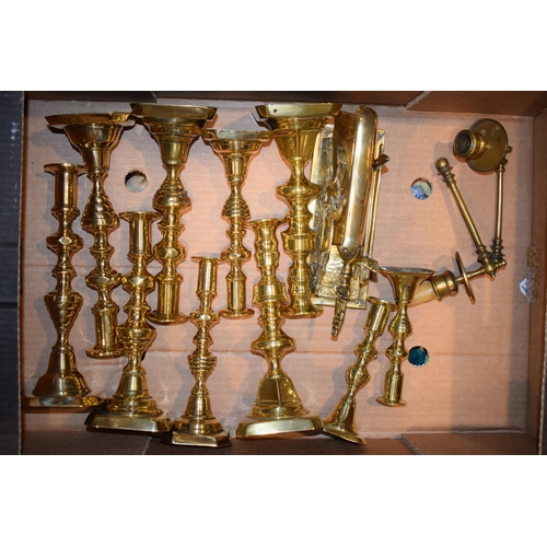 538 - A collection of antique brass candle sticks together with other similar vintage brass items, in pair... 