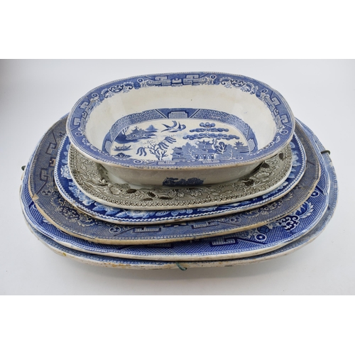 112 - A group of 19th century blue and white pottery Willow pattern platters and other similar. (q)