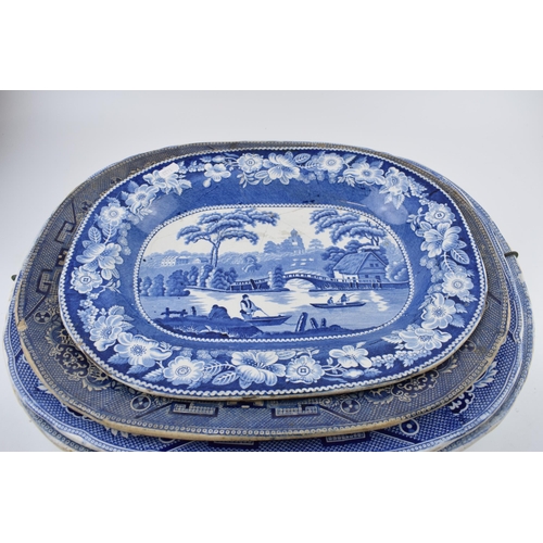 112 - A group of 19th century blue and white pottery Willow pattern platters and other similar. (q)