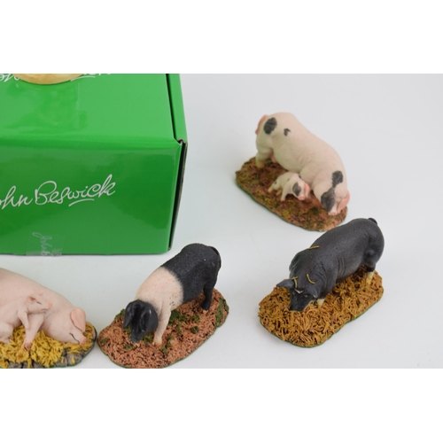 173 - A boxed Beswick Help for Heroes soldier with a collection of Royal Doulton resin pigs (7).