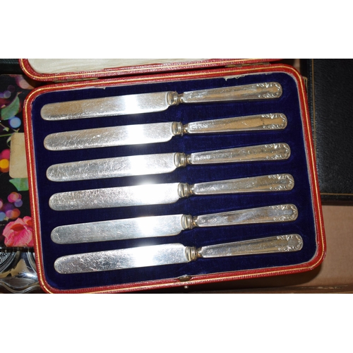 276 - A collection of metalware to include 2 cased sets of 6 silver handled knives, with silver plated cut... 