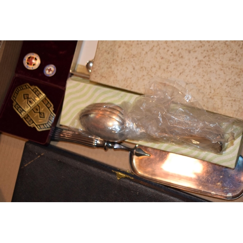 280 - A mixed collection of silver-plated items to include boxed cutlery sets together with enamel badges,... 