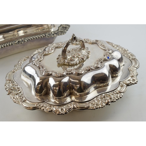 297 - A good quality pair of silver plated entree dishes, with ornate decoration, one by Walker and Hall (... 