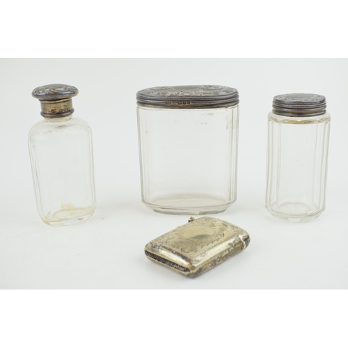 303 - A collection of silver-topped Victorian bottles together with a silver plated vesta case. Weight 36.... 