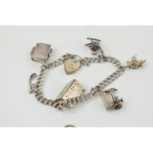 315 - A collection of silver items to include a silver charm bracelet (23.5 grams) with sewing machine cha... 