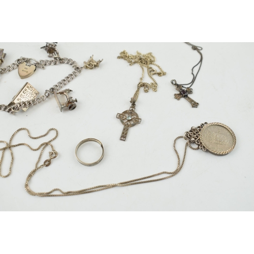 315 - A collection of silver items to include a silver charm bracelet (23.5 grams) with sewing machine cha... 