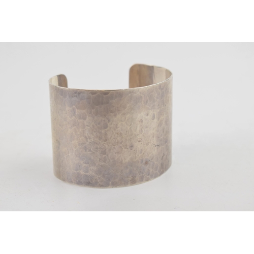 319 - Sterling silver hammered wide bangle, 65.2 grams, 52mm wide, London 2011, M C Hersey & Son Ltd (Stew... 