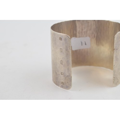 319 - Sterling silver hammered wide bangle, 65.2 grams, 52mm wide, London 2011, M C Hersey & Son Ltd (Stew... 