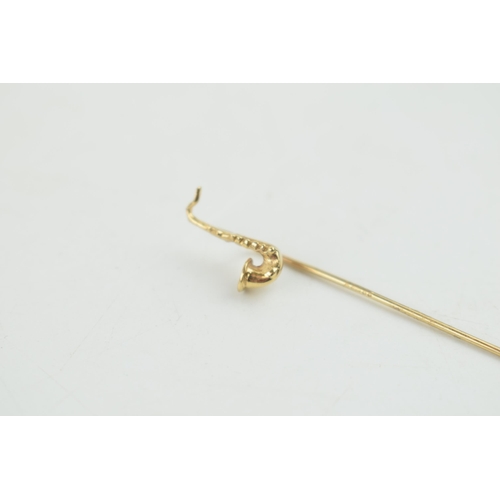 322 - 9ct gold stick pin with a saxophone head, 0.9 grams, 5.5cm tall.