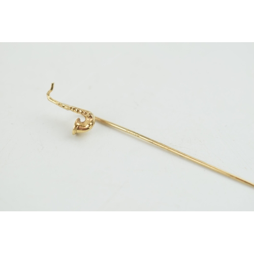 322 - 9ct gold stick pin with a saxophone head, 0.9 grams, 5.5cm tall.