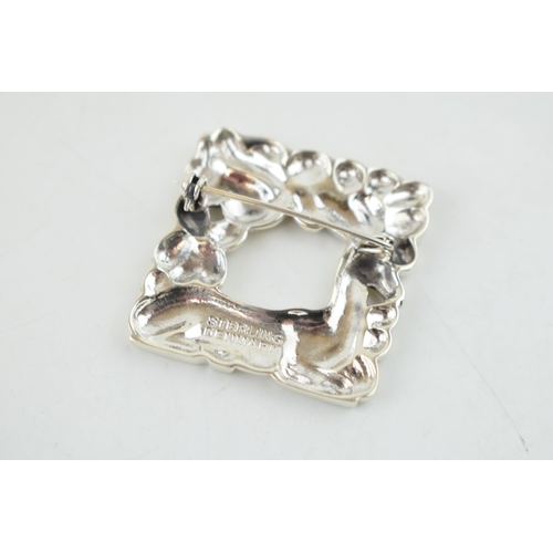 324 - Sterling silver brooch, with stylized decoration, featuring a deer and a squirrel, 32mm wide.