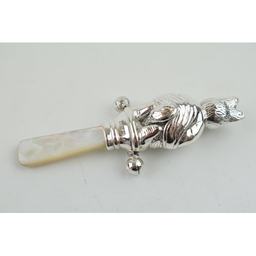 326 - Sterling silver baby rattle, with mother of pearl, in the form of a Beatrix Potter style character, ... 