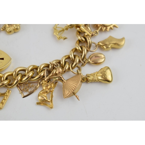 331 - 9ct yellow gold charm bracelet with padlock clasp and safety chain. To include 14 individual charms ... 