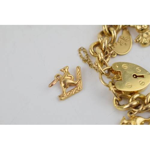 331 - 9ct yellow gold charm bracelet with padlock clasp and safety chain. To include 14 individual charms ... 