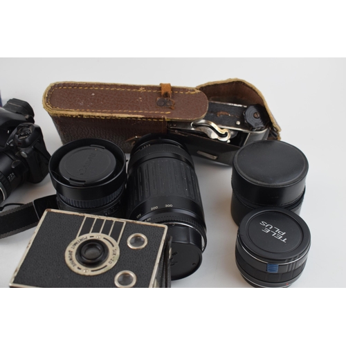 422 - A collection of vintage cameras and lenses to include Olympus OM10, Canon EOS and FinePix cameras to... 