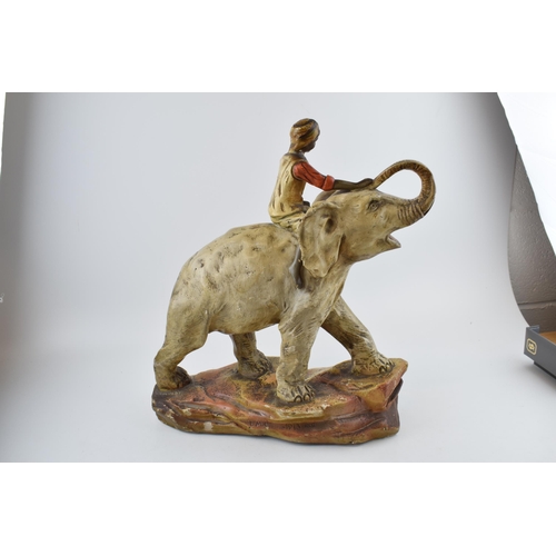 444 - A large mid 20th century plaster bust of an Indian boy riding an elephant, with registration number ... 