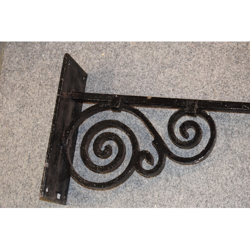 457 - Blacksmith made wrought iron wall-mountable hanger for shop or pub sign. Scroll work to iron with fo... 