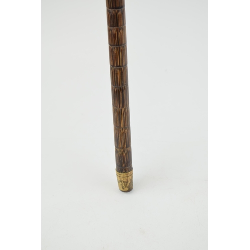 474 - An antique walking cane with white metal handle and brass ferrel. Length 92cm.