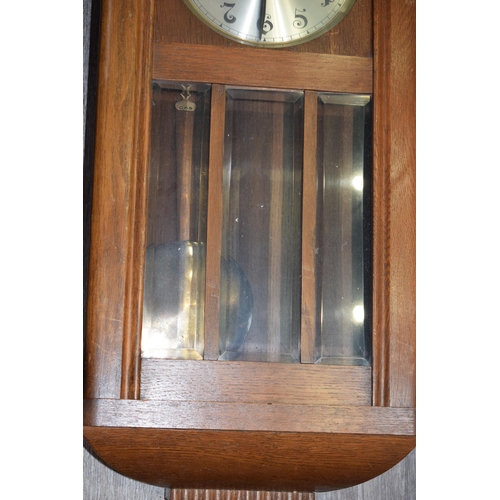 484 - Early - mid 20th century wall clock with chiming movement. Pendulum and key present. Height 78cm.