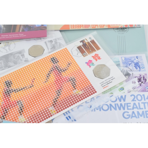 495 - A collection of 11 First Day Covers, with 50p coins, to include World Heritage Sites, For Valour, Pr... 