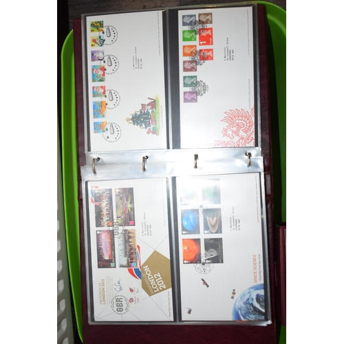 497 - A large and extensive collection of Royal Mail First Day Covers, in red leather bound albums, to inc... 