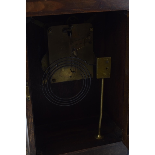 499 - A vintage chiming mantle clock in dark wood case. Pendulum movement. Height 35cm.