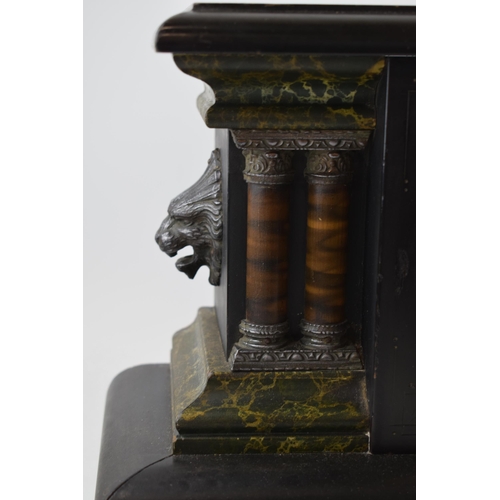 502 - Faux slate Victorian mantle clock with chiming movement. Lion's head garnitures with columns. 45cm x... 