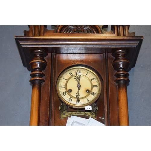 504 - An antique Vienna wall clock, brass and ceramic dial with Roman numerals. Chiming movement with pend... 