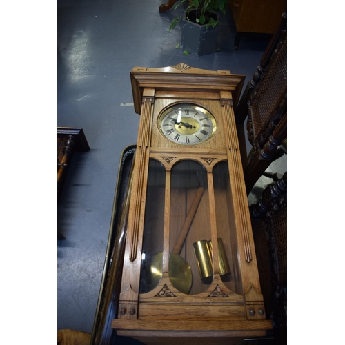 505 - A Vienna wall clock with brass dial and Roman numerals. Golden oak case. Chiming movement with pendu... 