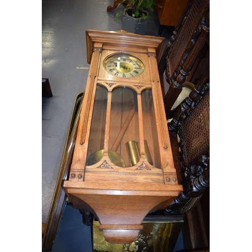 505 - A Vienna wall clock with brass dial and Roman numerals. Golden oak case. Chiming movement with pendu... 