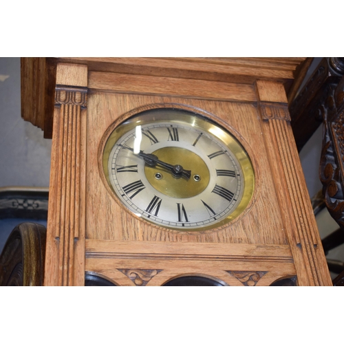 505 - A Vienna wall clock with brass dial and Roman numerals. Golden oak case. Chiming movement with pendu... 