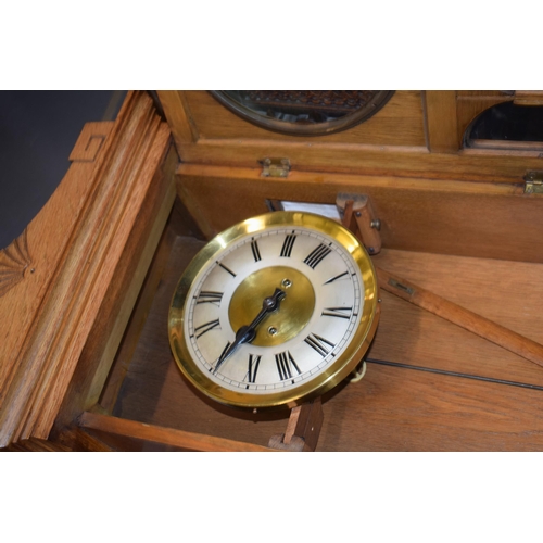 505 - A Vienna wall clock with brass dial and Roman numerals. Golden oak case. Chiming movement with pendu... 