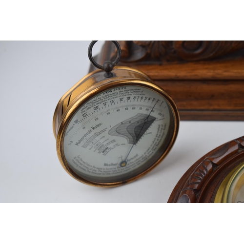 510 - A barometer with thermometer on round wooden mount diameter 22cm together with a 'Dew Point' gauge a... 