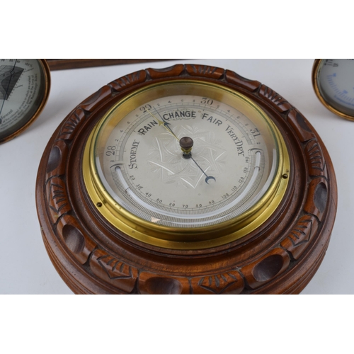 510 - A barometer with thermometer on round wooden mount diameter 22cm together with a 'Dew Point' gauge a... 