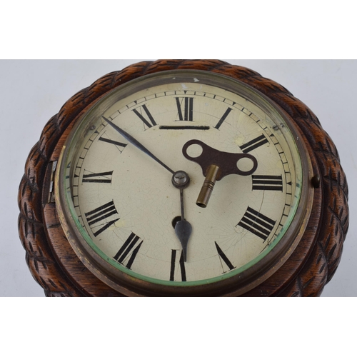 511 - An early 20th century ships clock with white dial and hand-painted Roman numerals. Diameter 24cm.