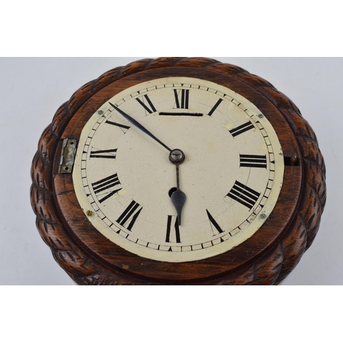 511 - An early 20th century ships clock with white dial and hand-painted Roman numerals. Diameter 24cm.