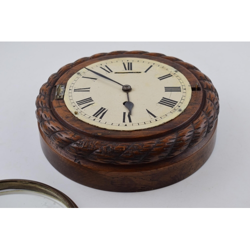 511 - An early 20th century ships clock with white dial and hand-painted Roman numerals. Diameter 24cm.