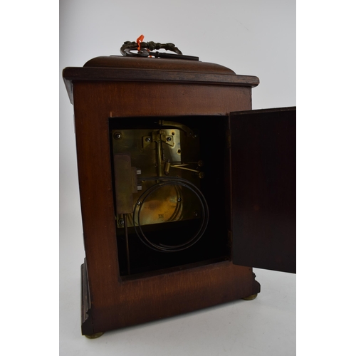 512 - Mahogany case mantle clock with pendulum chiming movement marked W&H SCH. With pendulum and key. Cas... 