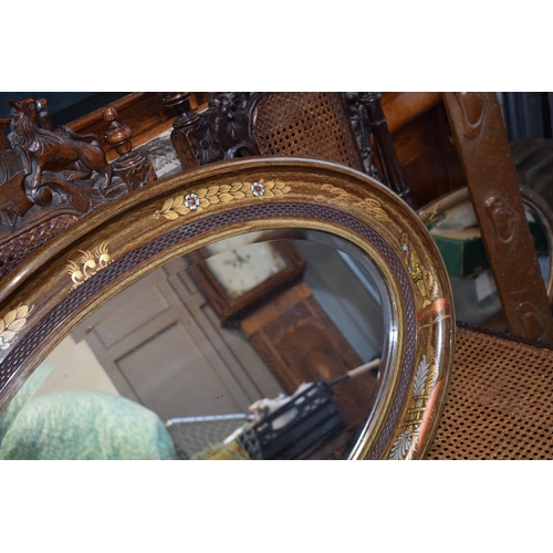 518 - Antique decorative oval shaped mirror with oriental inlaid gilt decoration. Bevelled glass. 87cm x 5... 