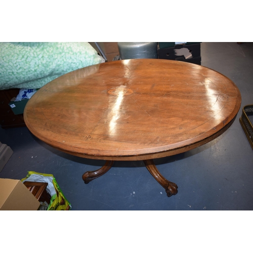 521 - Victorian quarter veneered burr walnut oval table with ornately carved legs on casters, satinwood in... 